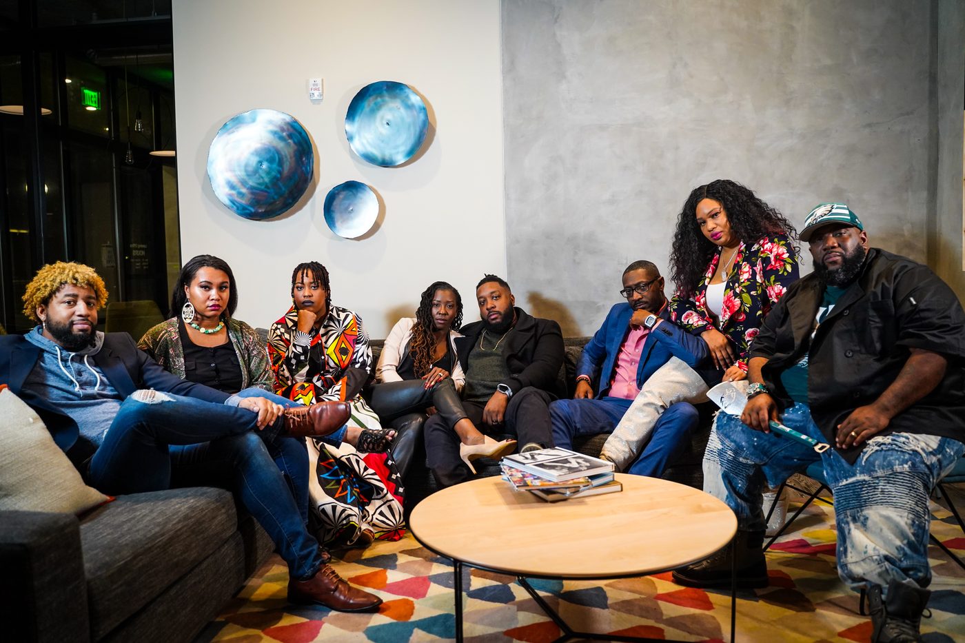 The EB Network team sitting together in a studio lounge